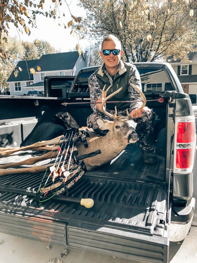 deer hunting; venison recipes; picture of a man holding a deer with a bow and arrow 