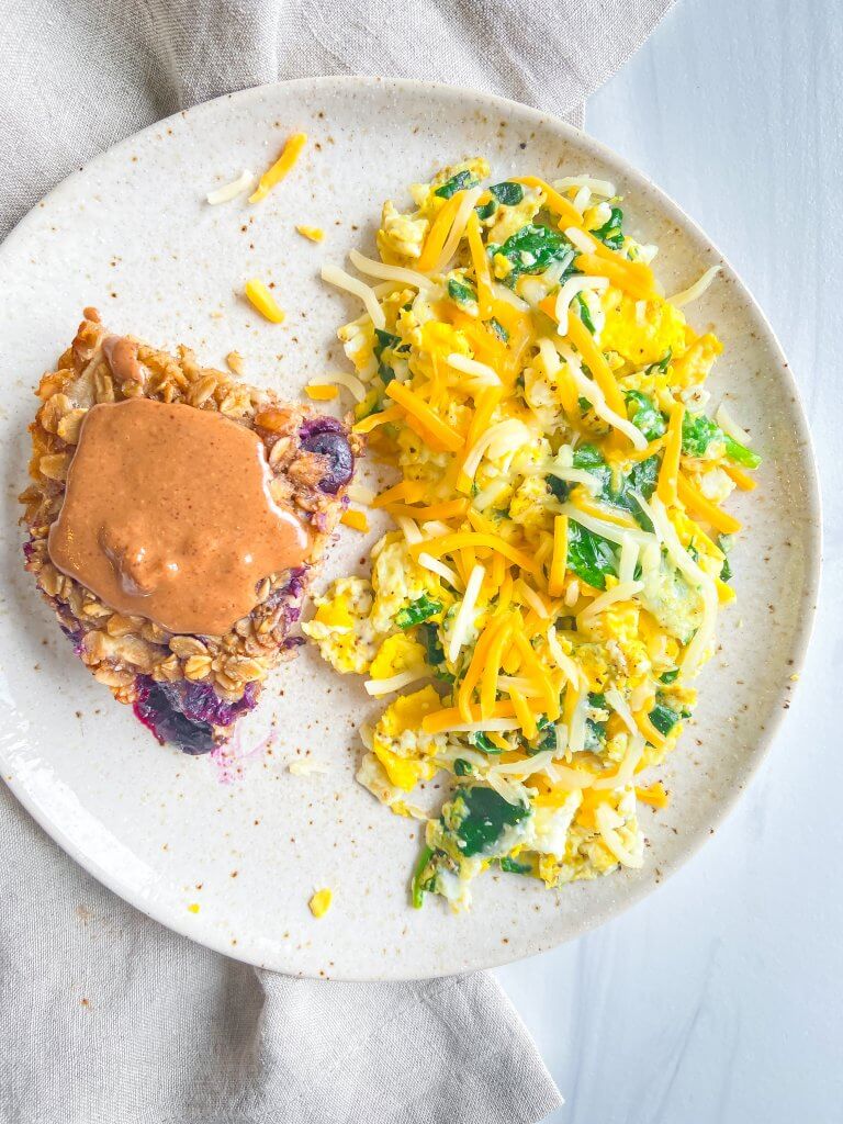 blueberry pecan baked oatmeal recipe, served up with scrambled eggs and spinach