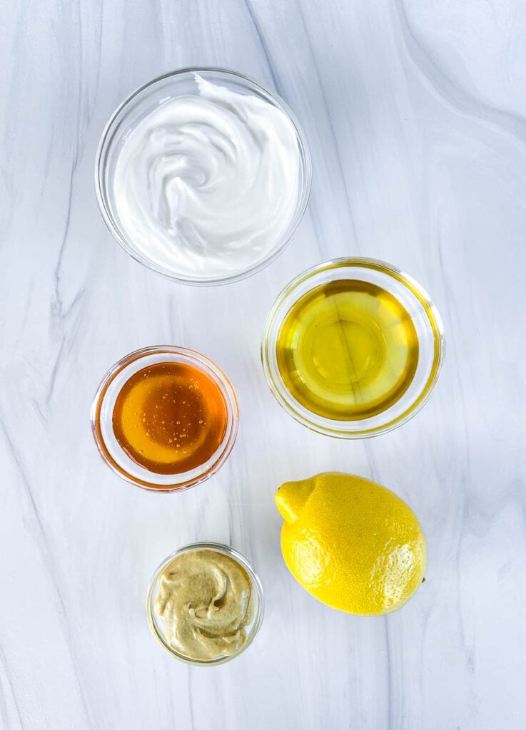 This is a picture of ingredients for homemade honey mustard Greek yogurt dressing.