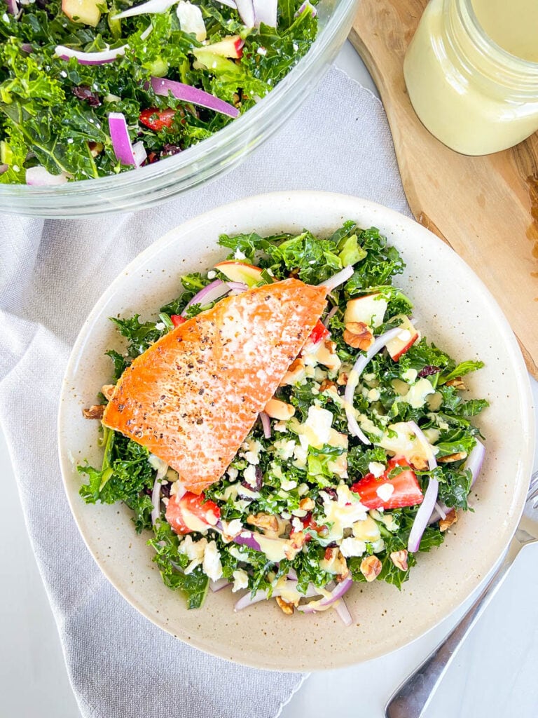 This is a photo of a kale salad with salmon topped with homemade Greek yogurt dressing. 