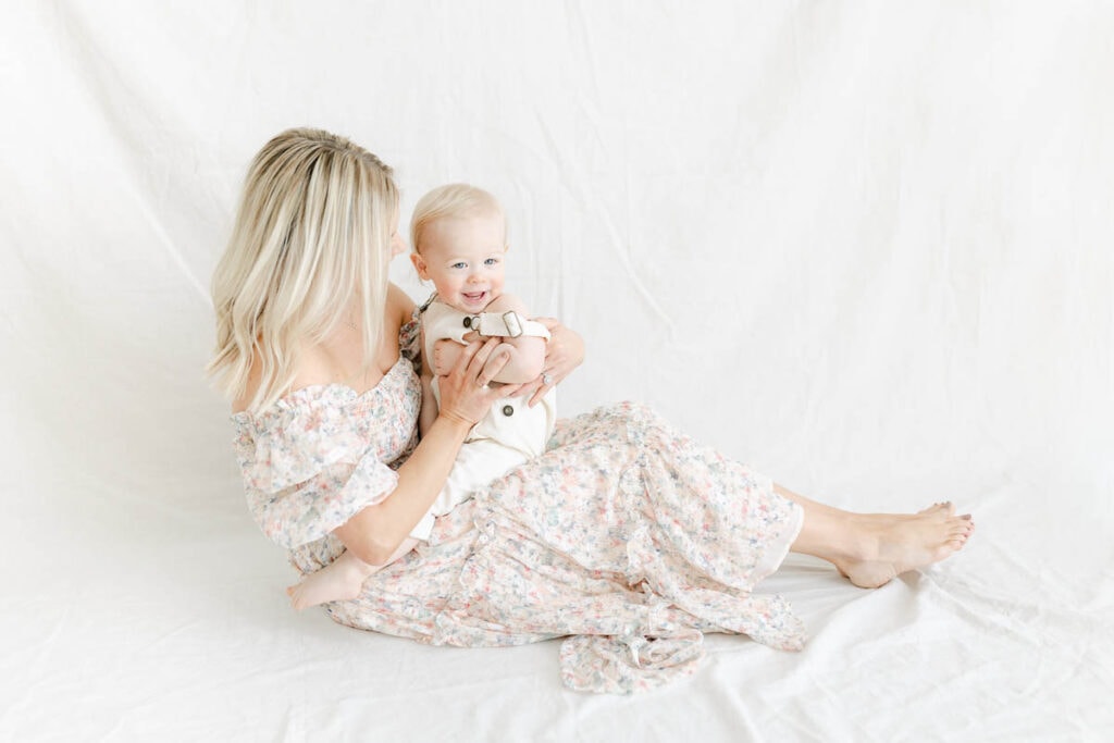 managing postpartum mental health; photo of mom and toddler on a white background 