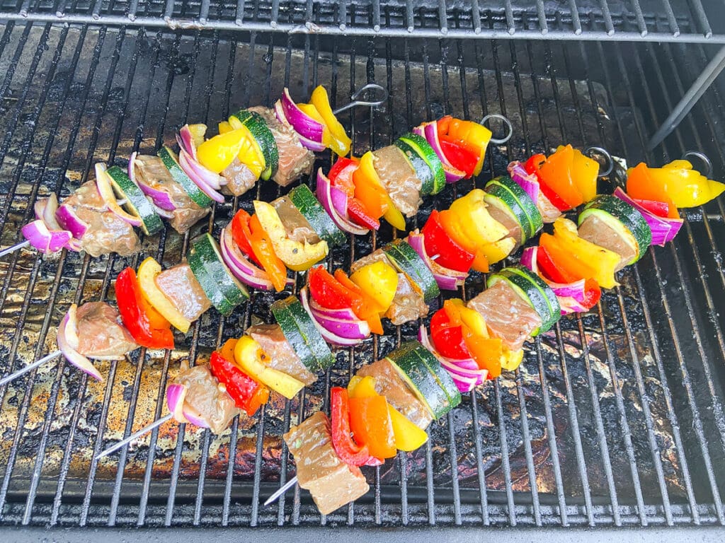 steak kebabs being cooked on the grill