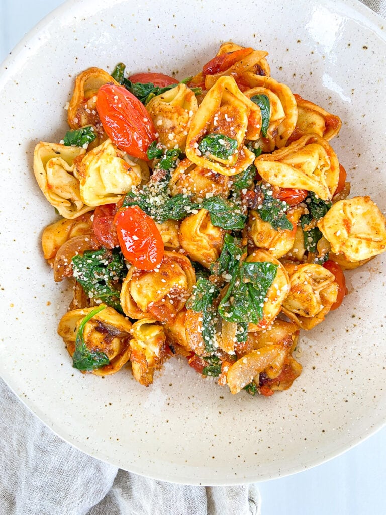 5 Delicious Ways to Use Pumpkin Pasta Sauce This Fall; spinach tomato chicken tortellini dish