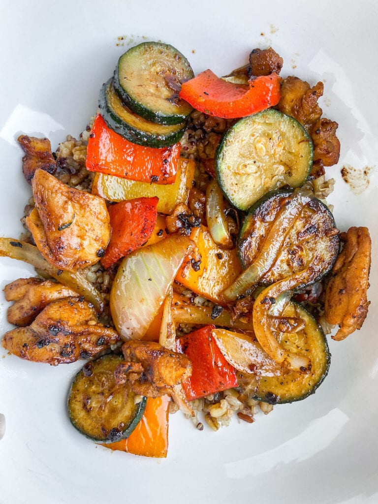 best blackstone griddle recipes; closeup of sauteed zucchini, squash, peppers and onions with chicken and brown rice, stir fry dish 